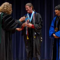 Provost passing award to awardee, with President Mantella
